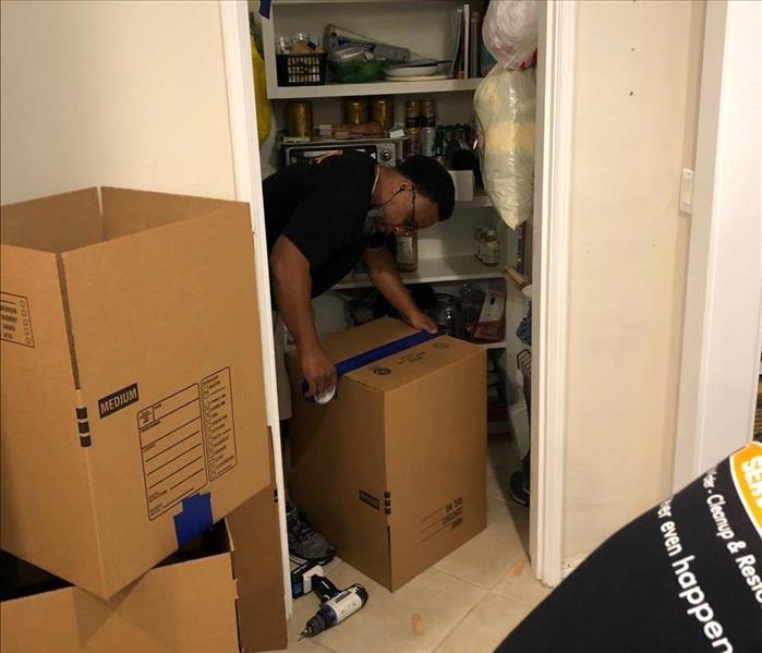 SERVPRO technicians with boxes for pack out in a kitchen